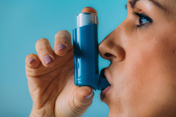 Woman Using Inhaler for Asthma - Фото, зображення