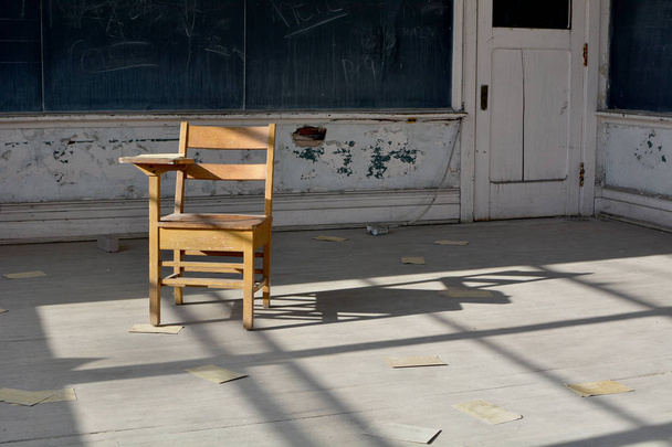 Vintage houten bureau in klaslokaal van een verlaten schoolgebouw - Foto, afbeelding