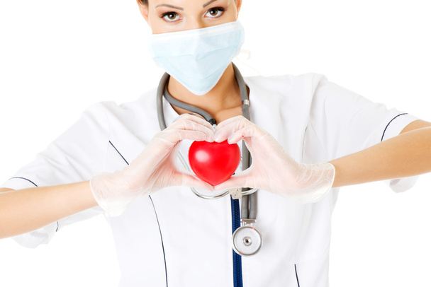 Young nurse with heart in her hand - Photo, image