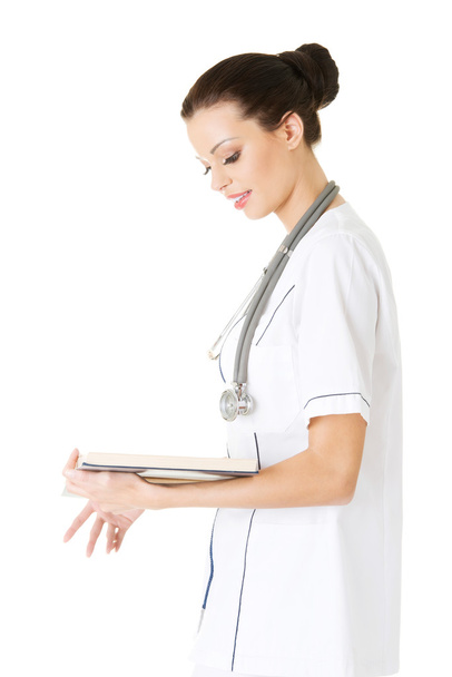 Attractive medicine student or doctor with book - Фото, изображение