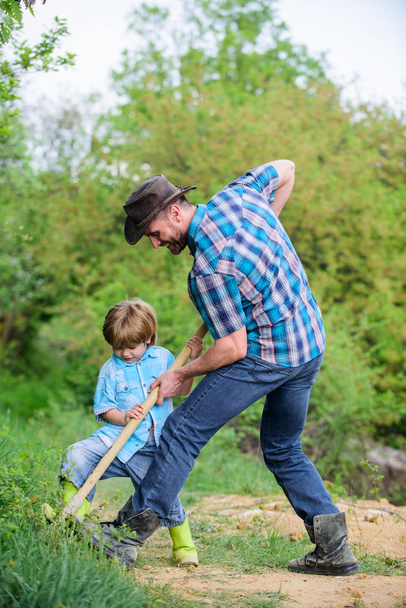 Find treasures. Little boy and father with shovel looking for treasures. Happy childhood. Adventure hunting for treasures. Little helper working in garden. Cute child in nature having fun with shovel - Fotografie, Obrázek