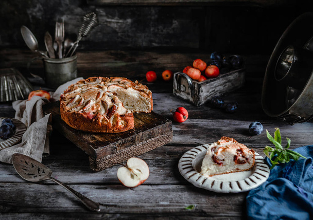 delicious homemade pie with apples and utensil on old dark table  - Zdjęcie, obraz