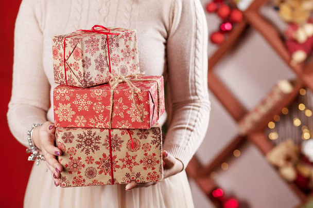 lWoman's  hands holding gift boxes. Christmas, new year, birthda - Zdjęcie, obraz