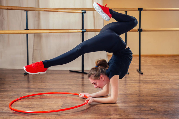 stretching and Pilates girls with red hoop in the gym - Foto, afbeelding