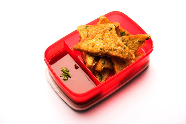 Lounas Box / Tiffin intialaisille lapsille, sisältää leipää munakas pakora tomaattiketsuppia tai ituja, valikoiva painopiste
 - Valokuva, kuva