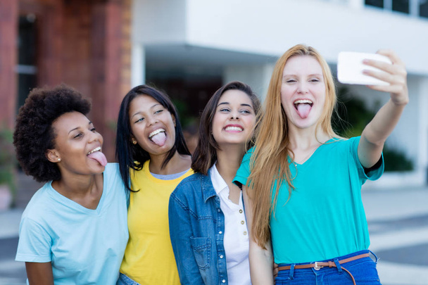 Group of multi ethnic young adult woman taking crazy selfie - Fotoğraf, Görsel