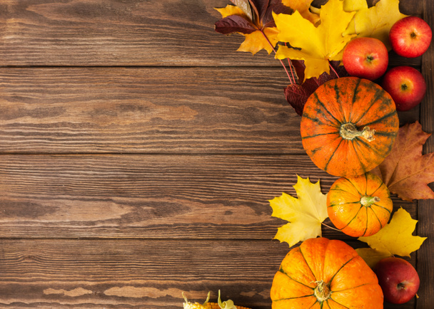 Herbst Stillleben reife Kürbisäpfel Mais gefallen gelben Blättern auf einem hölzernen Hintergrund. Dankbares Herbstkonzept. - Foto, Bild