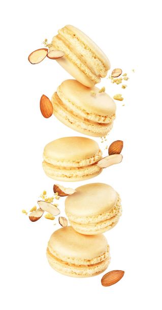 stack of macaroons fly on a white background with almonds - Photo, Image