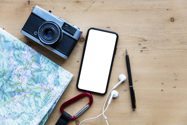 Modern smartphone with travel items. Blank screen phone display - Fotografie, Obrázek