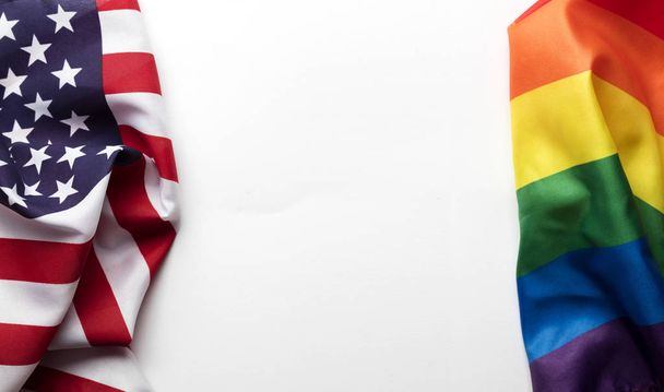 American stars and stripes flag alongside a gay Pride LGBT rainb - Фото, изображение