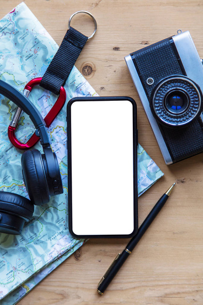Modern smartphone with travel items. Blank screen phone display - 写真・画像