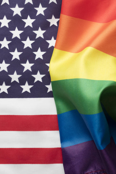 American stars and stripes flag alongside a gay Pride LGBT rainb - Foto, Bild