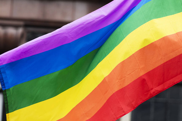 Gay rainbow flag at an LGBT gay pride march in London - Фото, зображення