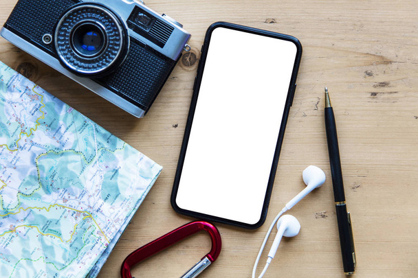 Modern smartphone with travel items. Blank screen phone display - Foto, Bild