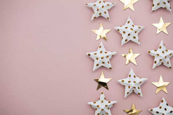 White and gold star decorations on a pastel pink. Seasonal festi - Photo, Image