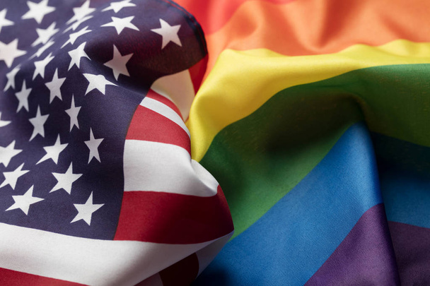 American stars and stripes flag alongside a gay Pride LGBT rainb - Photo, image