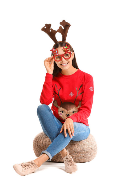 Funny young woman in Christmas sweater on white background - Photo, Image