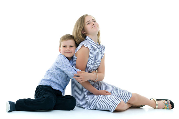Brother and sister, boy and girl posing in the studio. Friendshi - Photo, image