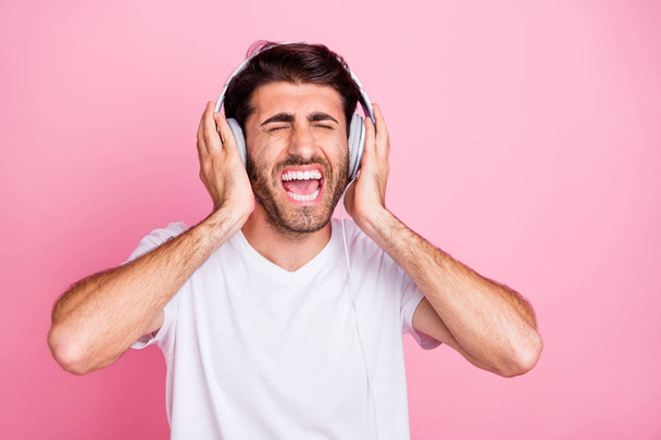 Portrait of funny funky positive middle astern singer man have rest relax use headset listen favorite song sing enjoy free time weekends wear style clothes isolated over pastel color background - Photo, image