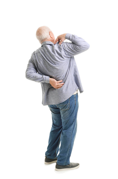 Senior man suffering from back pain on white background - Photo, Image