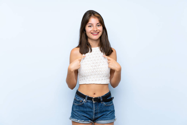 Young woman over isolated blue background with surprise facial expression - Fotografie, Obrázek