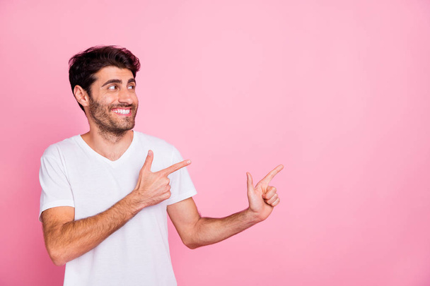 Porrait of funny funky middle eastern man point index finger copyspace show ads suggest select advertisements promo wear white clothes isolated over pastel color background - Foto, Imagen