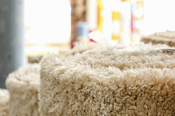 Soft rolled carpet in shop, closeup - 写真・画像