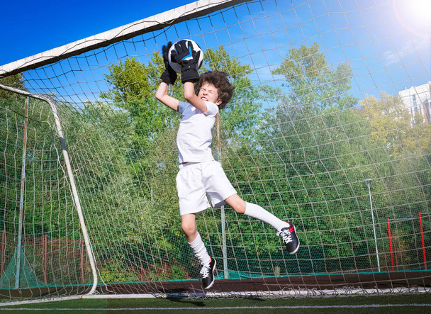 Young goalkeeper in football gate. Football, soccer player. Child in action - Photo, image