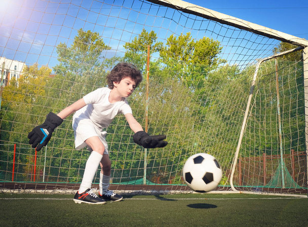 Young goalkeeper in football gate. Football, soccer player. Child in action - Foto, immagini