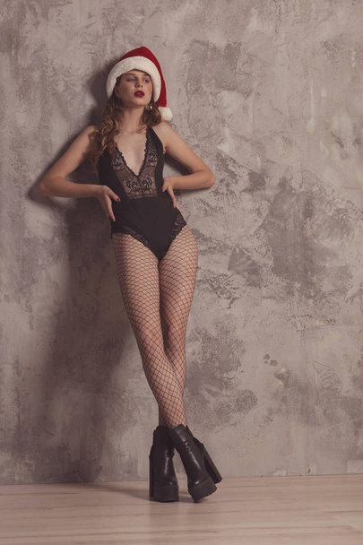 Fashionable confident woman with long legs in black sexy bodysui - Foto, Bild
