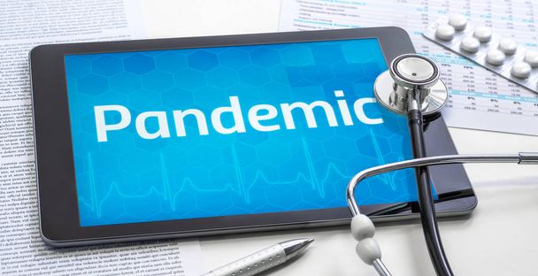 The word Pandemic on the display of a tablet - Photo, Image