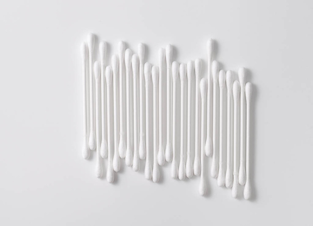A pile of cotton swabs on a gray background. Space for text - Fotografie, Obrázek