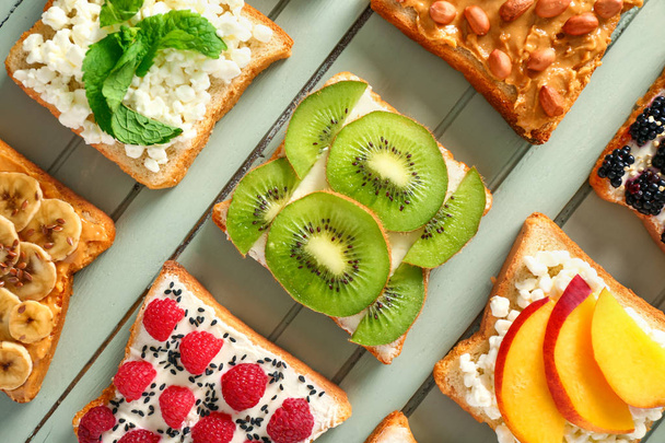 Different tasty sandwiches on wooden background - Φωτογραφία, εικόνα
