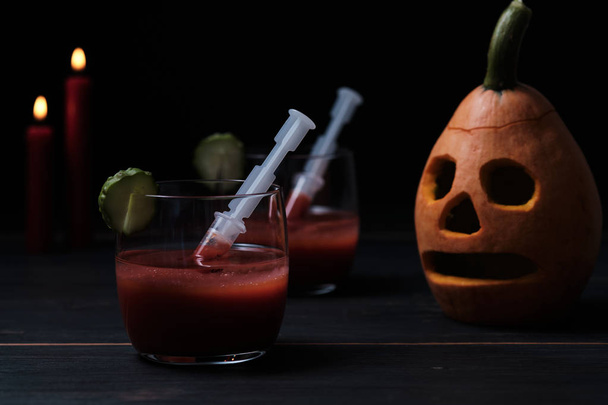 Halloween sangrento mary cocktail e sinistro jack lanterna em uma mesa de madeira escura
. - Foto, Imagem