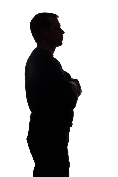 Porträt eines jungen Mannes, Seitenansicht - dunkle, isolierte Silhouette - Foto, Bild
