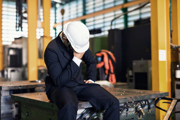 Sad fired businessman in factory  - Фото, изображение