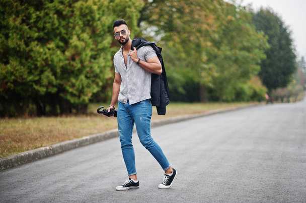 Fashionable tall arab beard man wear on shirt, jeans and sunglas - Foto, afbeelding