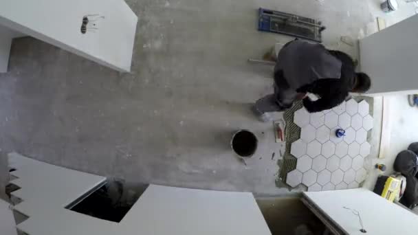 Man lay hexagon tiles on floor. Timelapse - Footage, Video