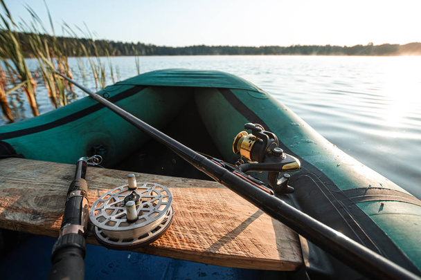Inflatable boat on the lake at sunrise. Fishing hobby vacation concept. Copy space - Valokuva, kuva