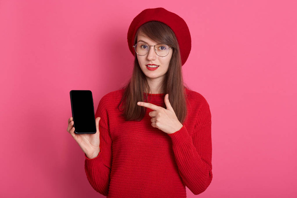 Close up portrait of appealing Caucasian woman holding smartphon - Photo, Image