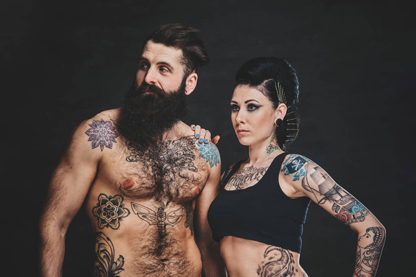 Portrait of tattooed man and woman at photo studio - Photo, Image