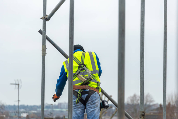 Professional Scaffolders working on scaffolding in the UK - Фото, изображение