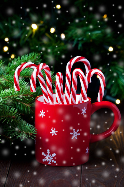 Candy canes with red and white stripes in  ceramic mug, Christmas concept - Photo, Image