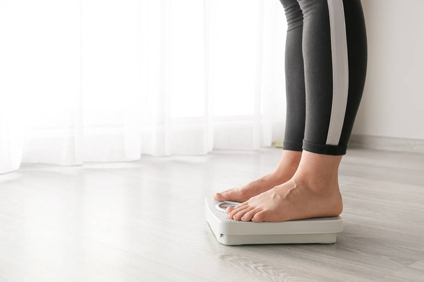 Woman standing on scales. Weight loss concept - Photo, Image