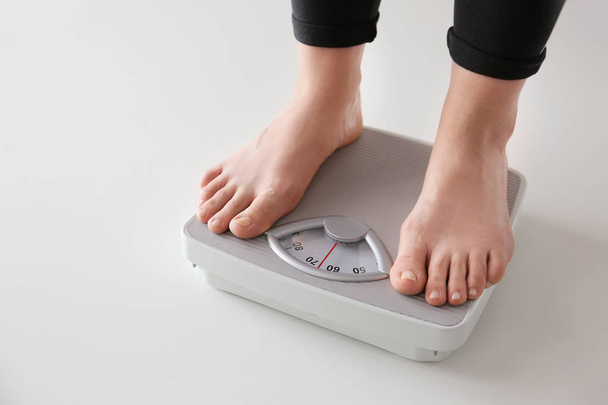 Woman standing on scales. Weight loss concept - Photo, Image