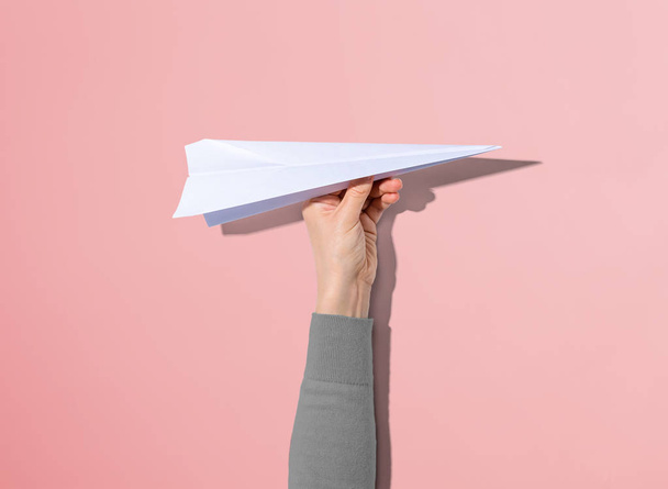 Person holding a paper airplane - Foto, Bild