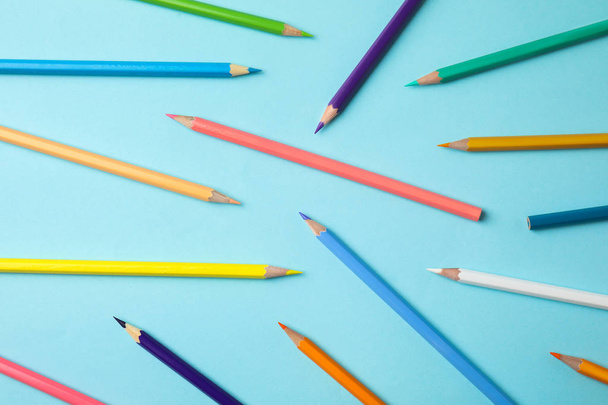 Composition with color pencils on blue background - Fotó, kép