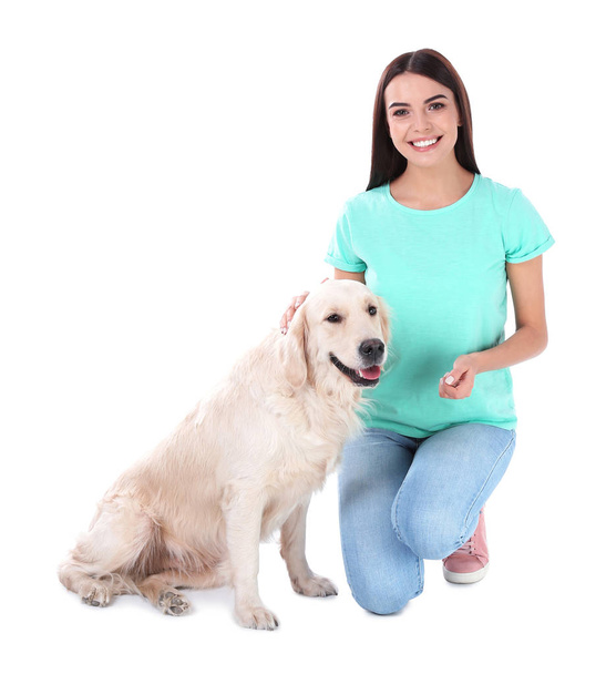Young woman and her Golden Retriever dog on white background - Fotó, kép