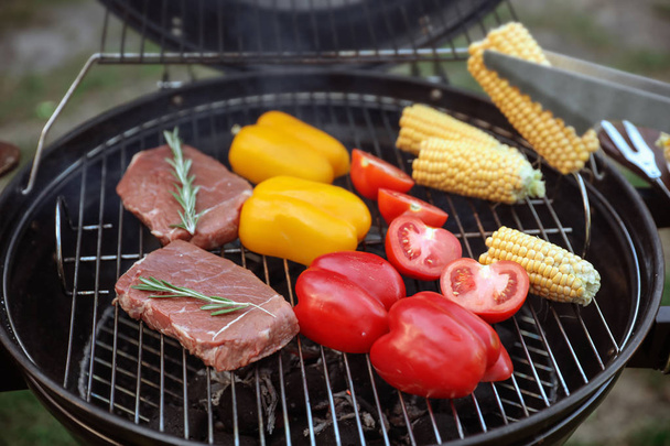 Cooking fresh food on barbecue grill outdoors, closeup - Φωτογραφία, εικόνα