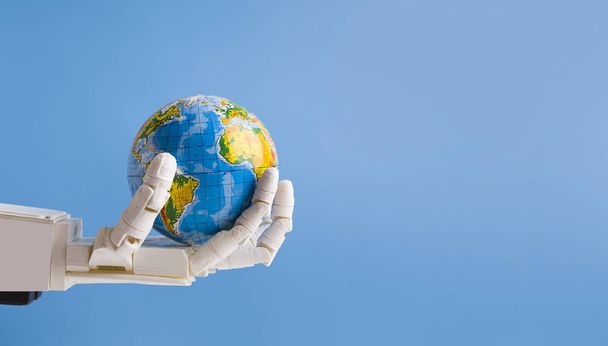 Robot holding Earth globe in hand, blue panorama background - Φωτογραφία, εικόνα